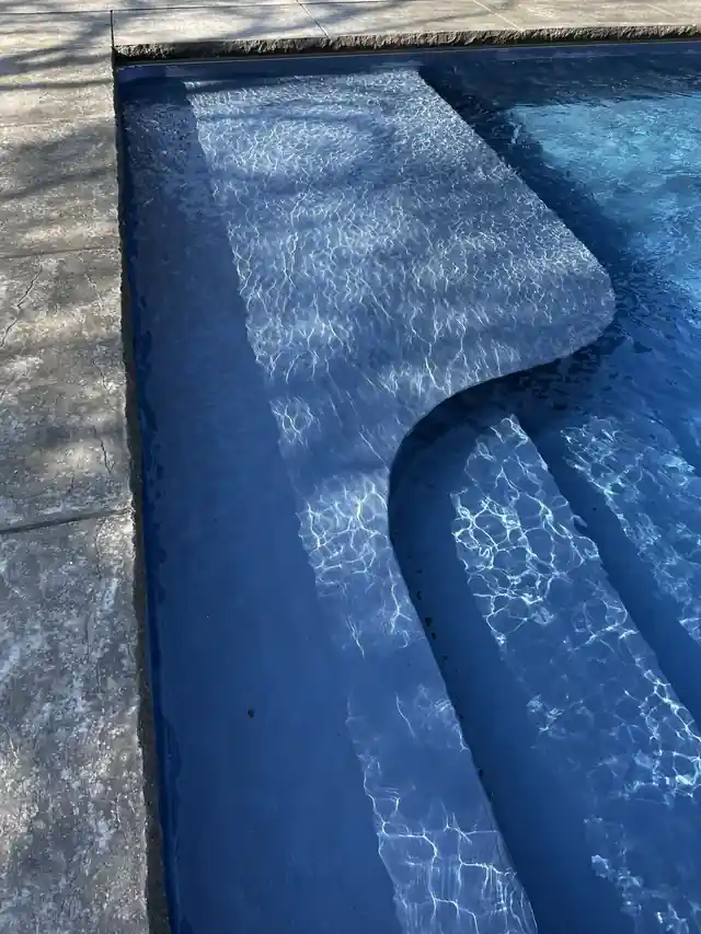 Curved step with light ripples across it, shot upright