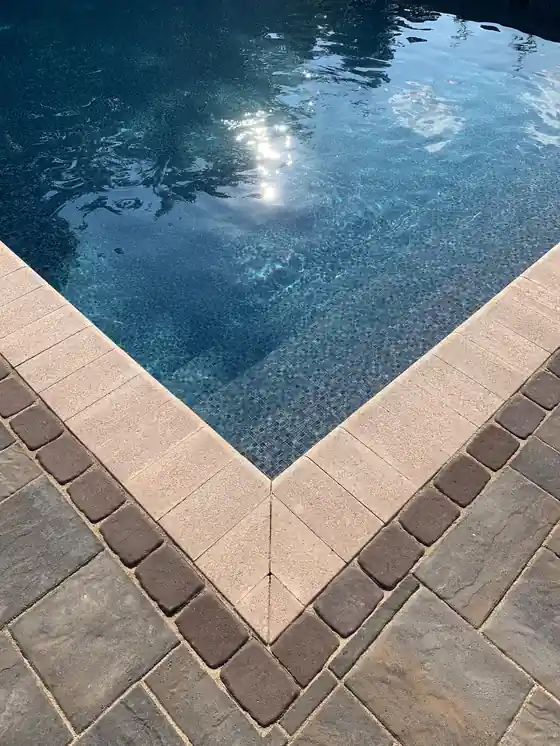 Dark liner water meeting a paver corner, shot upright
