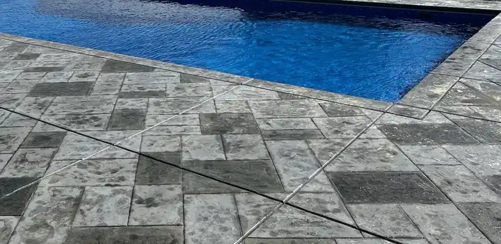 Stamped patio running up to the edge of the pool