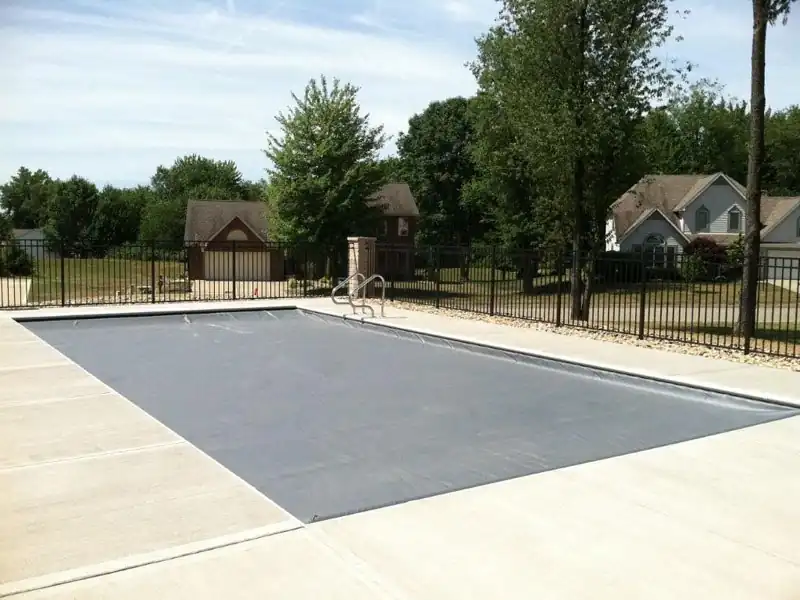 Automatic cover closed across an inground pool